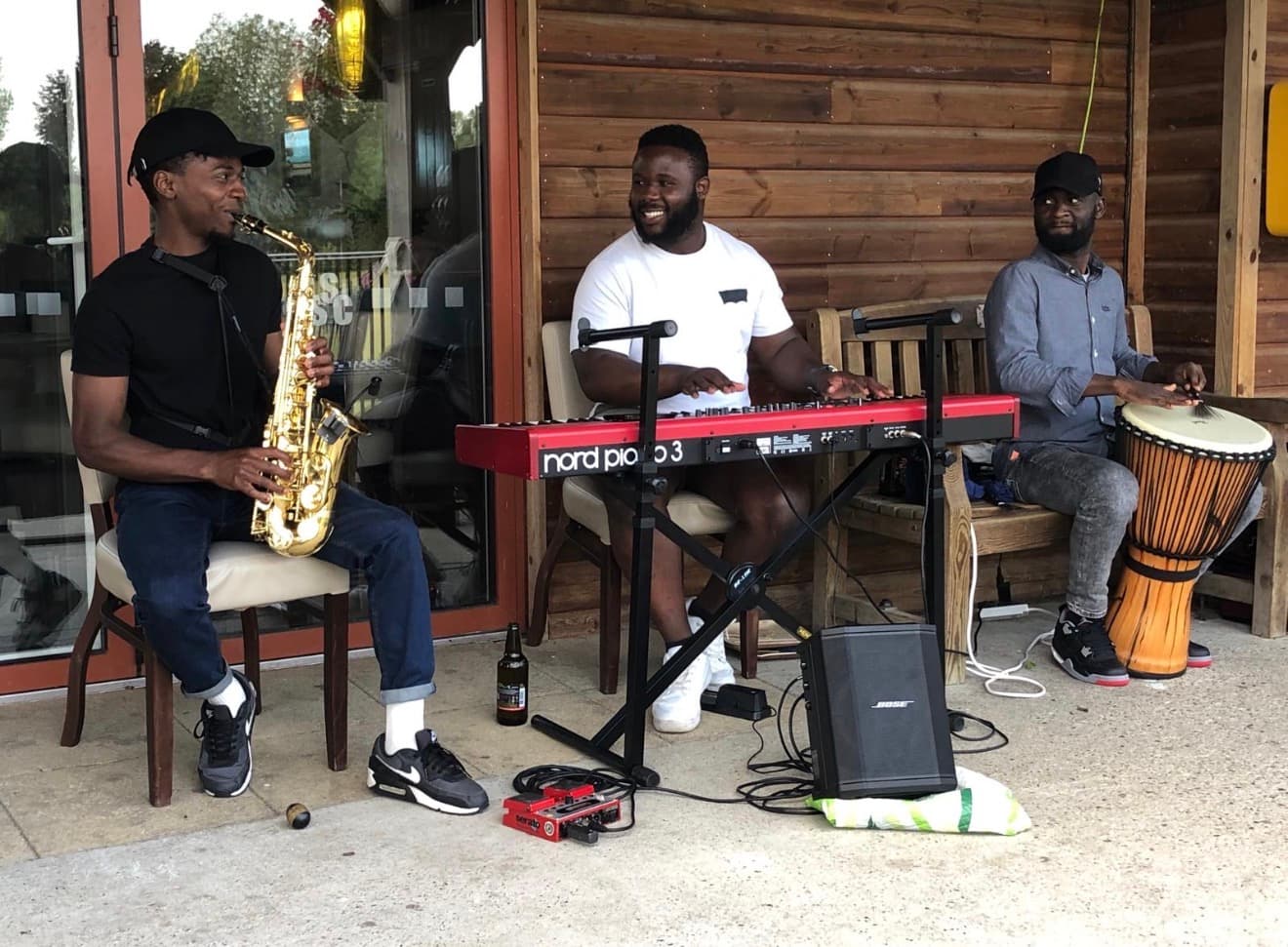 The AfroSync Trio performing: saxophone, piano and djembe