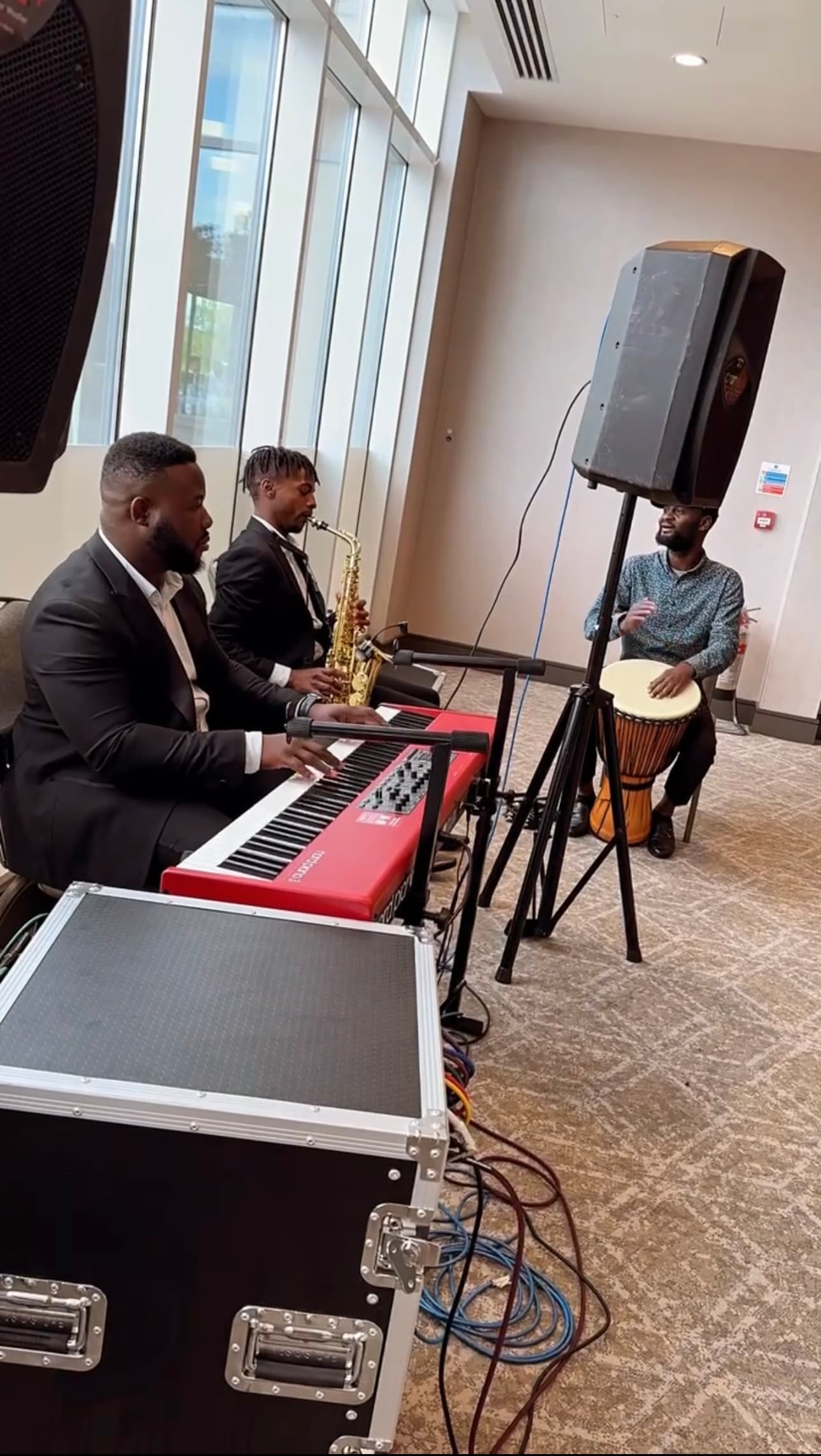 AfroSync trio performing live: piano, saxophone and djembe